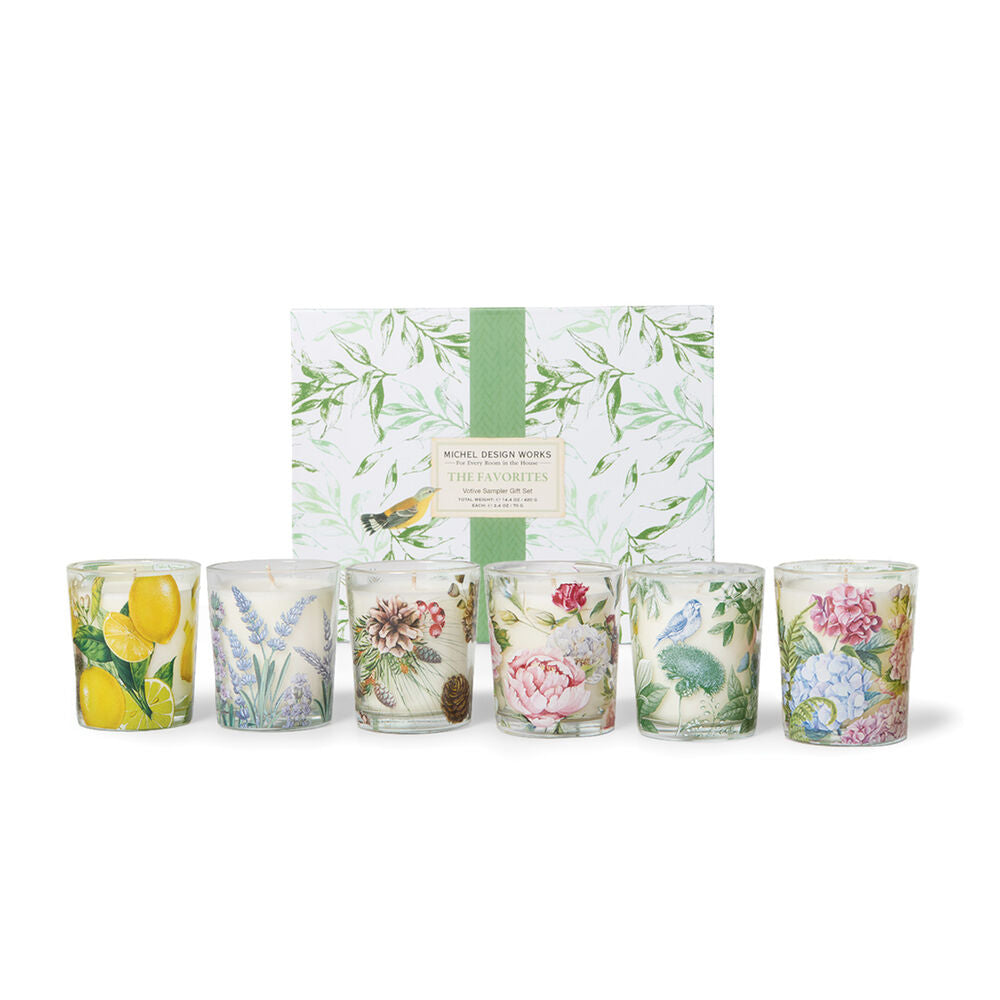 Set of six floral-themed candles with a decorative box on a white background