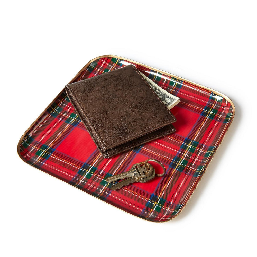 Royal Stewart Tartan tray with a brown leather wallet and keys on a red plaid tray on a white backround.
