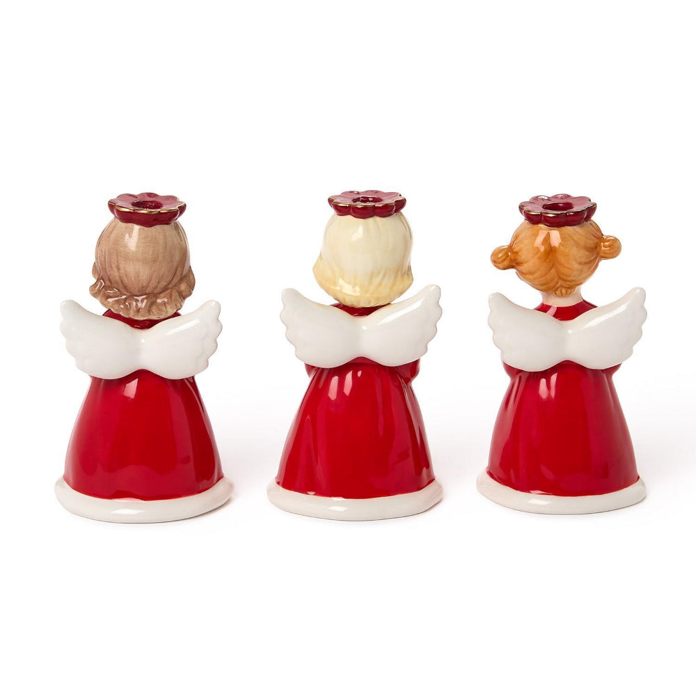 A photo of the back of three angel figurine candle holders in red dresses with white wings and red holos holding christmas decorations star, cardinal and wreath  on a white background.