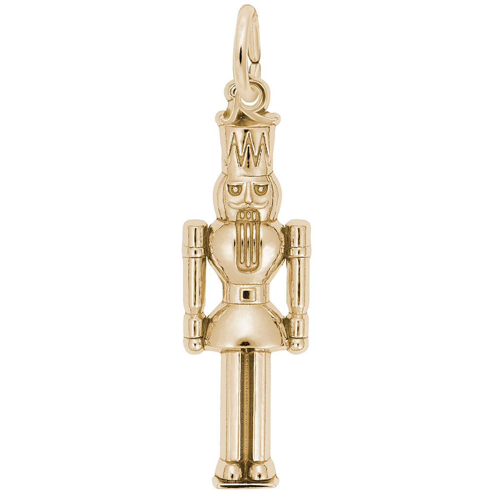 A polished gold nutcracker king charm with detailed engravings, shown against a solid white background.