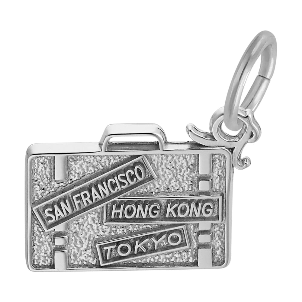 Reverse side of a silver charm shaped like a suitcase with 'San Francisco', 'Hong Kong', and 'Tokyo' text on a white background