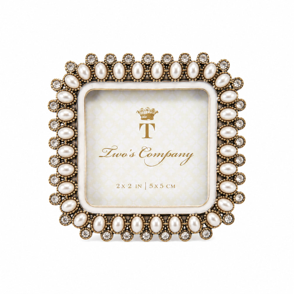 A square decorative picture frame with a pearl and crystal-embellished border, shown on a plain white background. The center insert displays the brand name 'Two's Company' with a gold crown logo.
