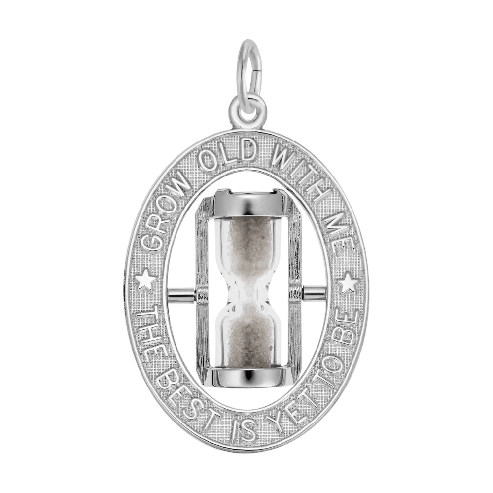 A silver oval charm featuring an hourglass in the center, surrounded by a textured border with the engraved text 'GROW OLD WITH ME THE BEST IS YET TO BE'.