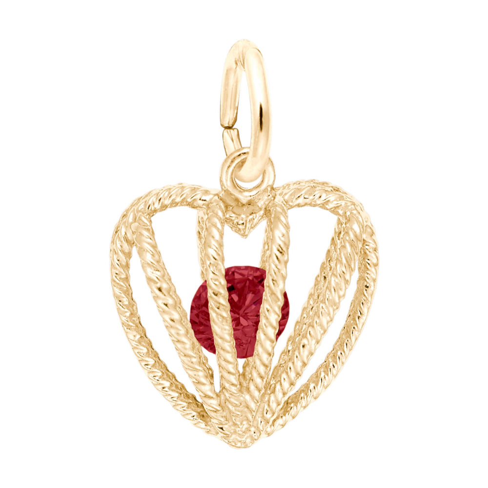 Gold heart-shaped pendant with a red gemstone on a white background