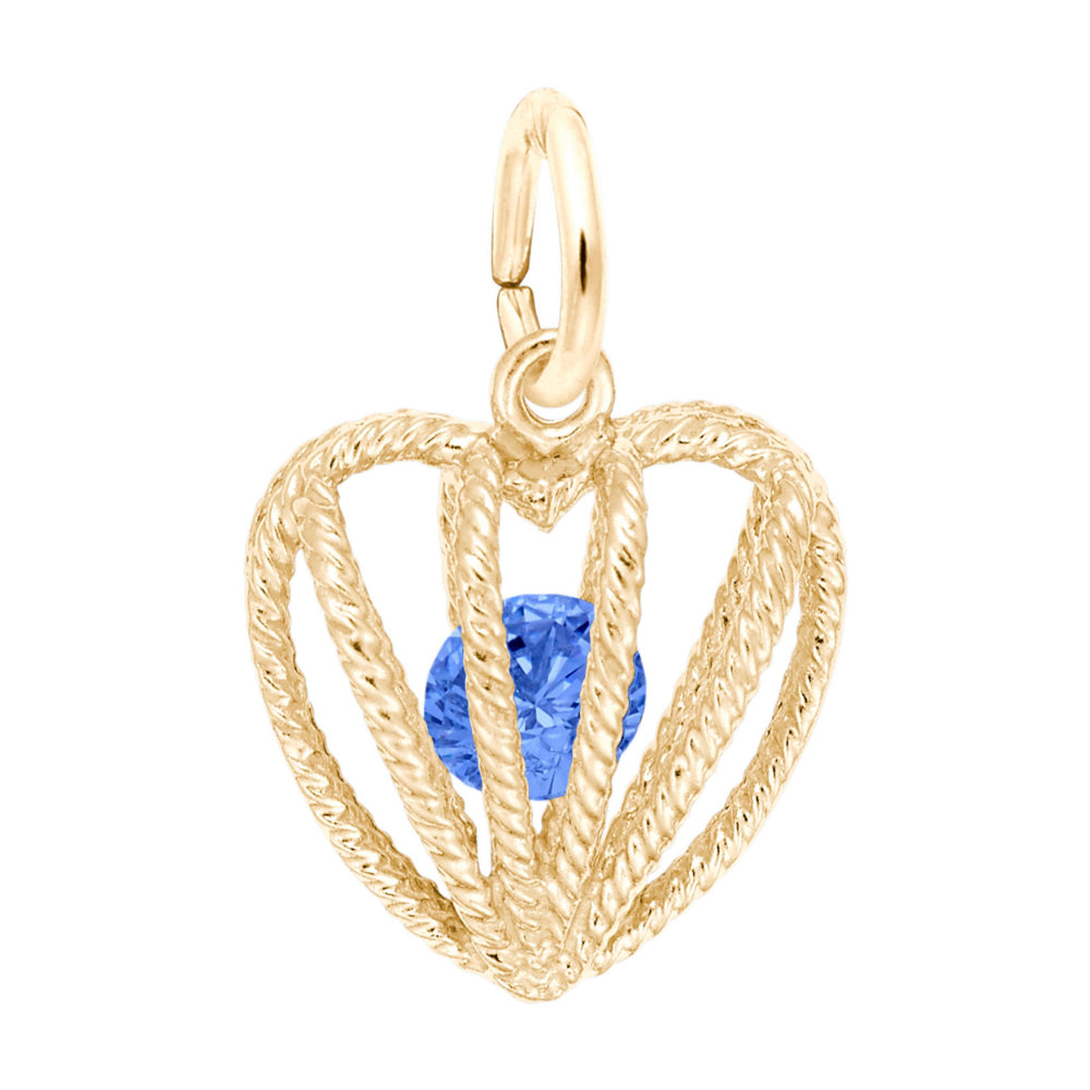 Gold heart-shaped pendant with a blue gemstone on a white background