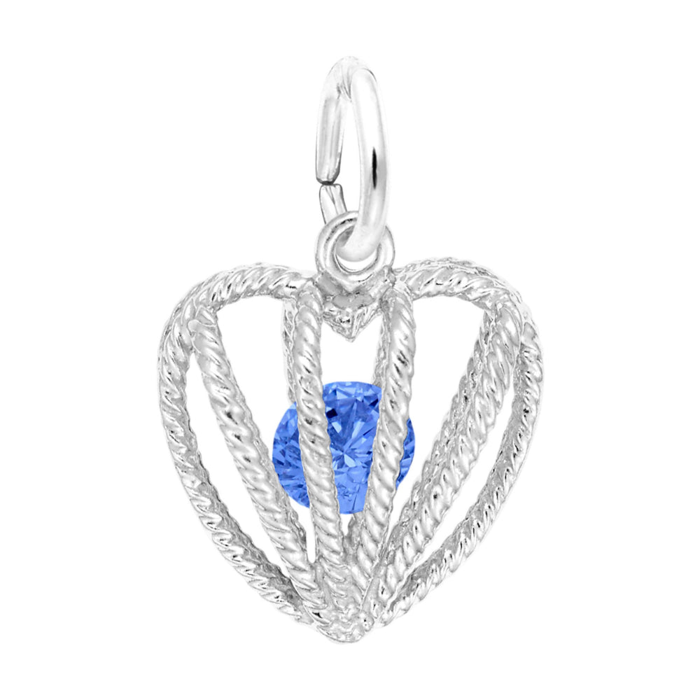 Silver heart-shaped pendant with a blue gemstone on a white background