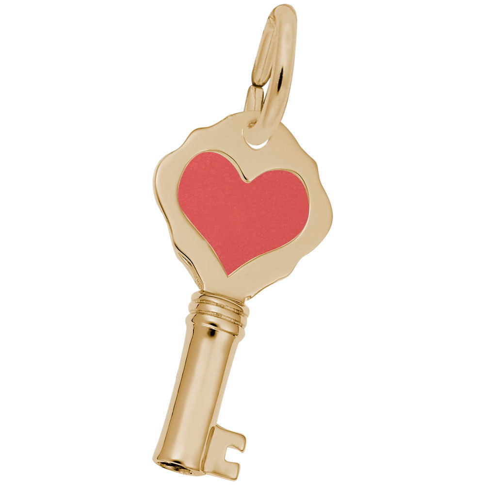 Gold key-shaped charm with a red heart on a white background