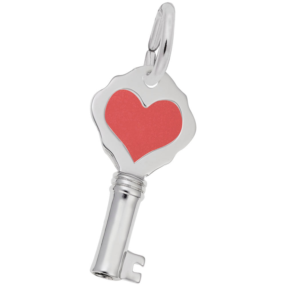 Silver key-shaped charm with a red heart on a white background