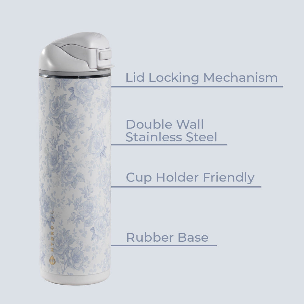 A stainless steel travel tumbler with a light blue floral pattern on a white background, shown with text callouts describing its features: Lid Locking Mechanism, Double Wall Stainless Steel, Cup Holder Friendly, and Rubber Base.