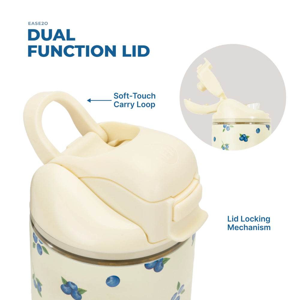 An insulated tumbler with a cream-colored dual function lid and a blueberry pattern, shown with text callouts explaining the soft-touch carry loop and lid locking mechanism, plus a circular inset showing the lid open.
