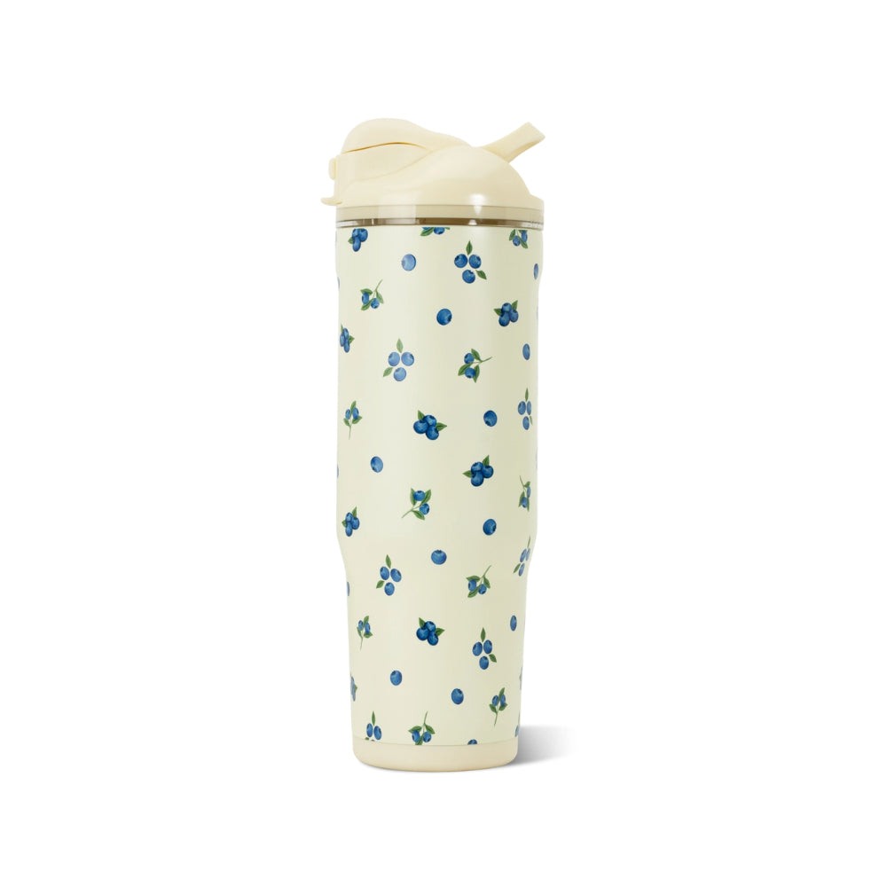 A tall insulated travel tumbler with a cream-colored lid and a matching cream body decorated with a small blue berry pattern, shown on a plain white background.