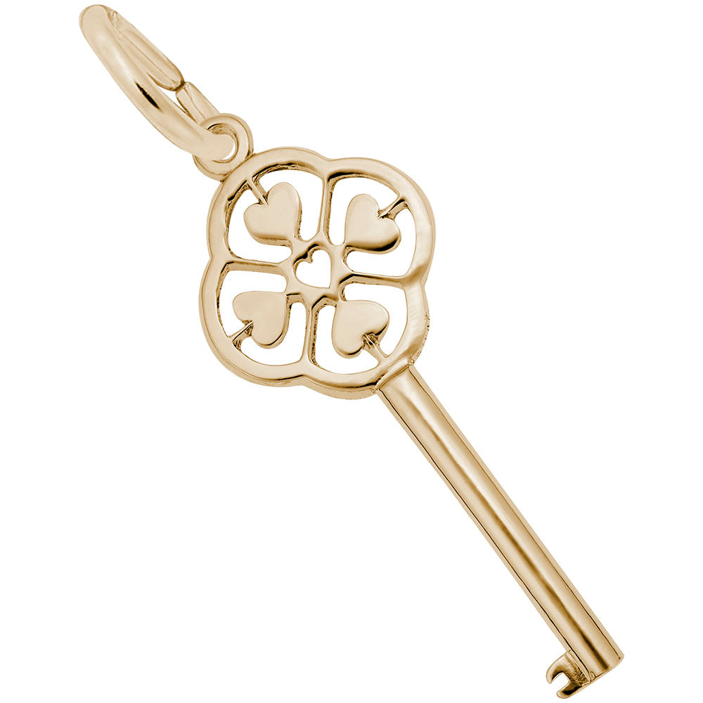 Gold key-shaped charm with decorative heart design on a white background