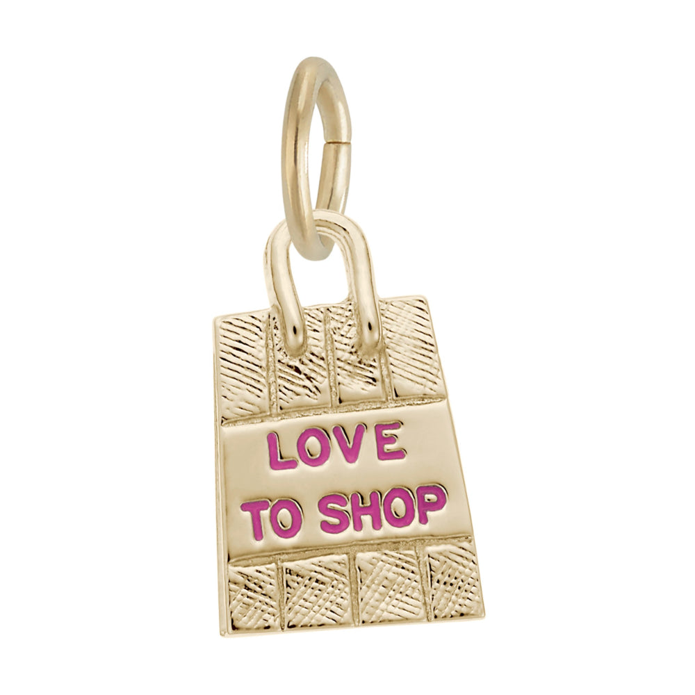 A gold charm shaped like a shopping bag with the words 'LOVE TO SHOP' in pink enamel, shown on a plain white background.
