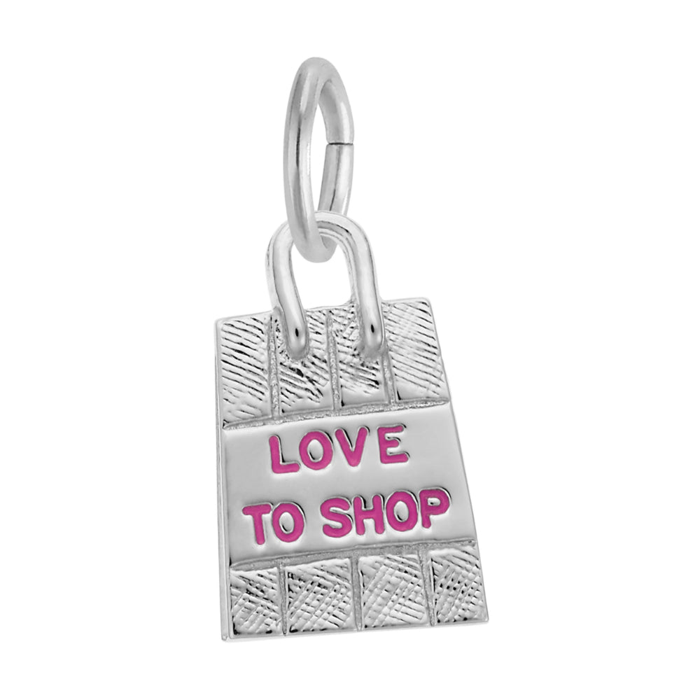 A silver charm shaped like a shopping bag with the words 'LOVE TO SHOP' in pink enamel, shown on a plain white background.