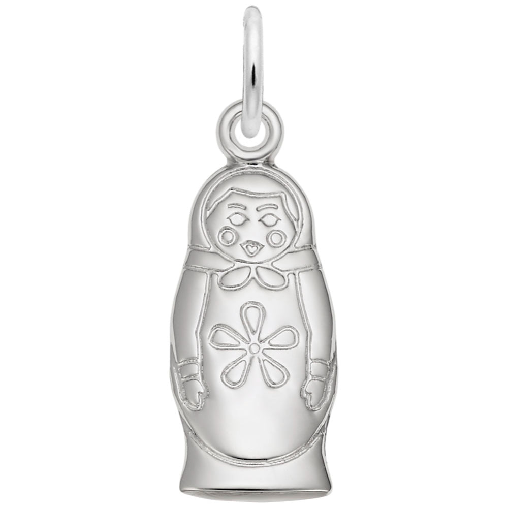 Silver charm shaped like a Russian nesting doll featuring an engraved face, floral motif on the chest on a white background