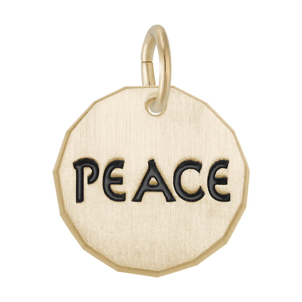 Gold hexagonal disc charm with 'PEACE' engraved on it, on a white background