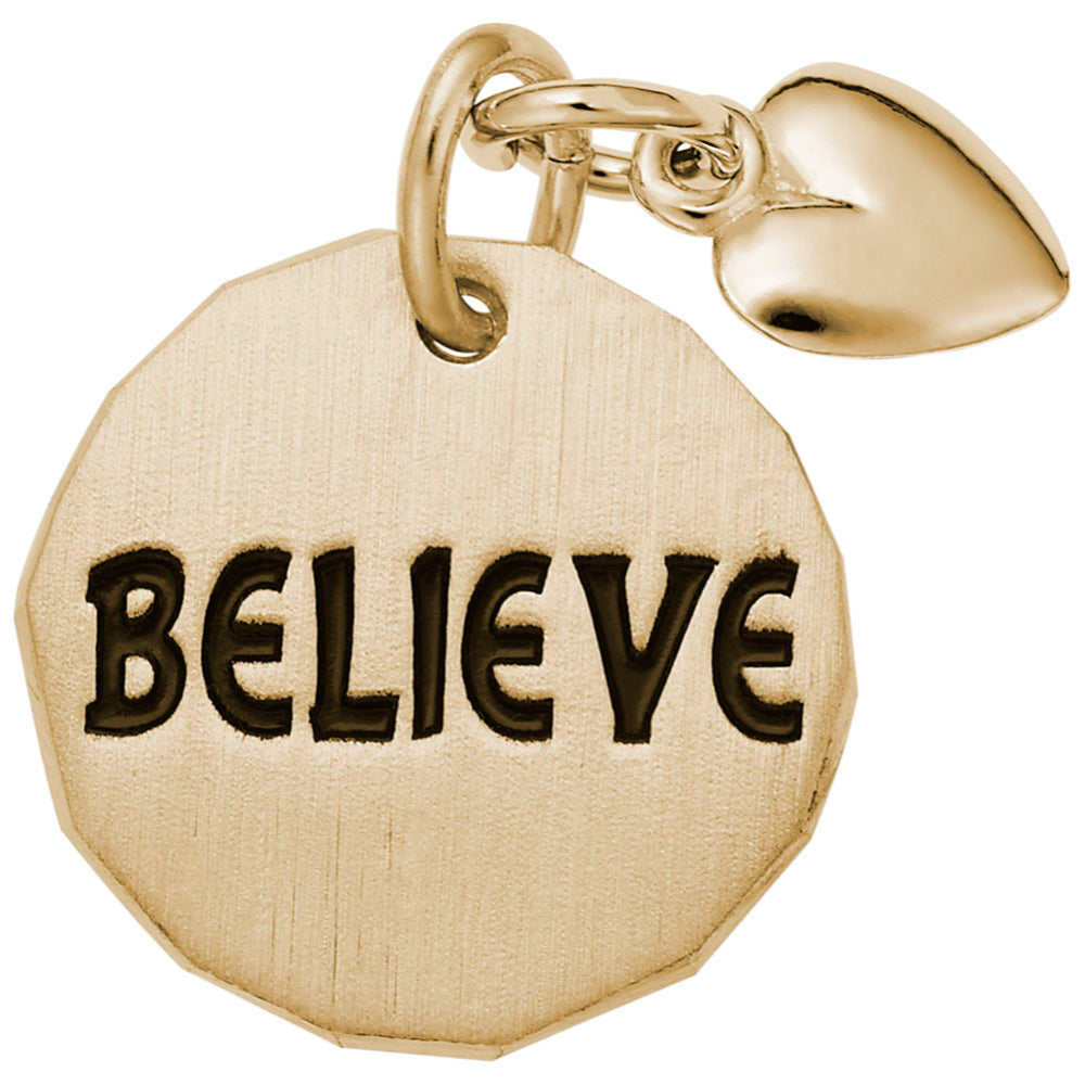 Gold disc charm with 'BELIEVE' engraved on it and a heart shaped dangle on a white background 