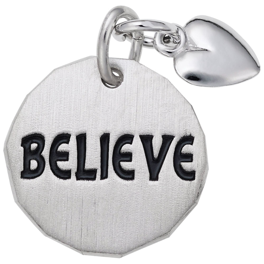 Silver disc charm with 'BELIEVE' engraved on it and a heart shaped dangle on a white background 
