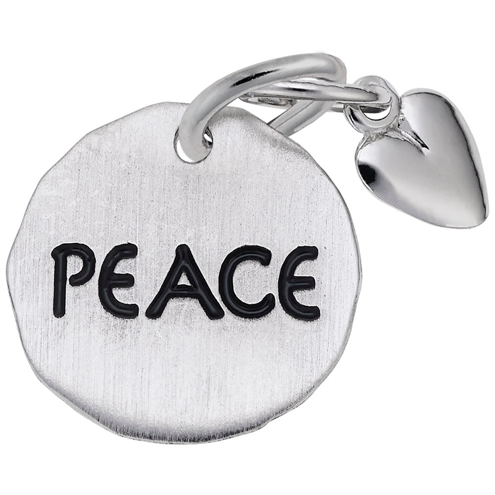 Silver disc charm engraved with 'PEACE' and a heart shaped dangle on a white background
