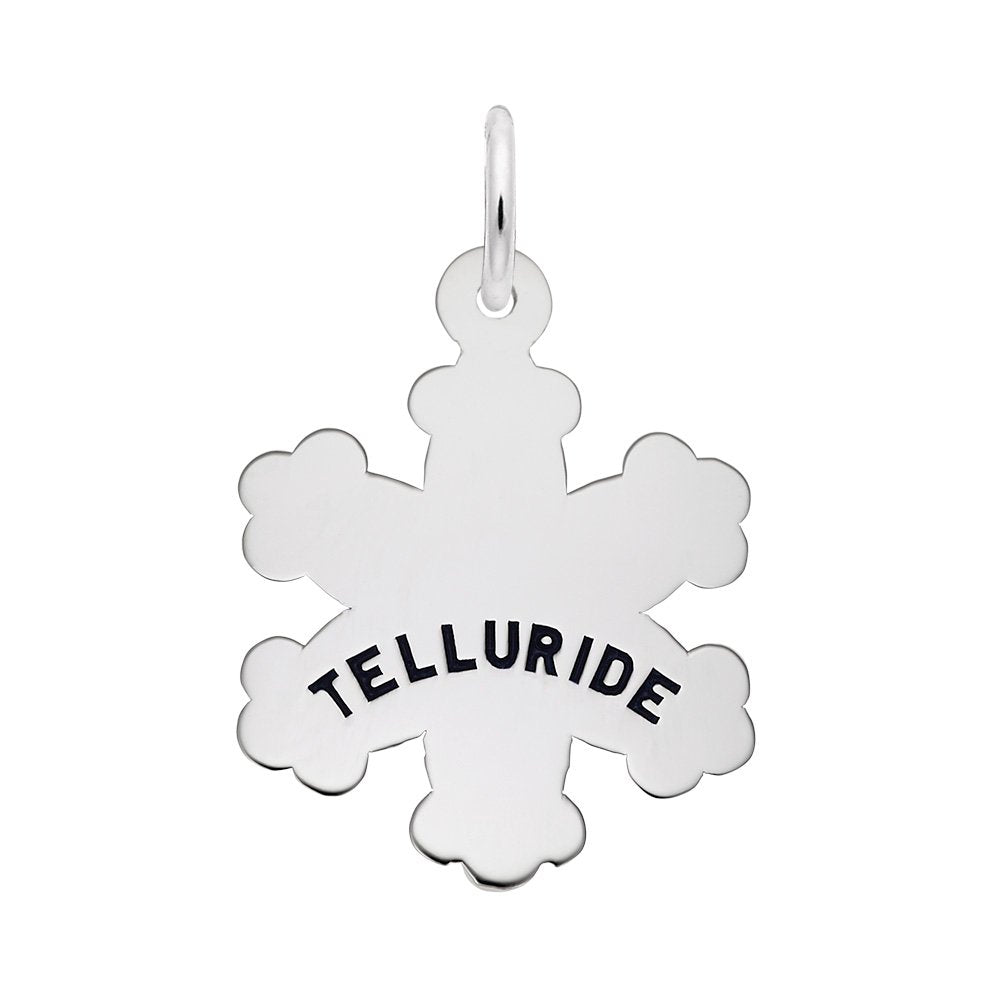 A silver snowflake charm engraved with the word 'TELLURIDE' in black capital letters, shown on a plain white background.