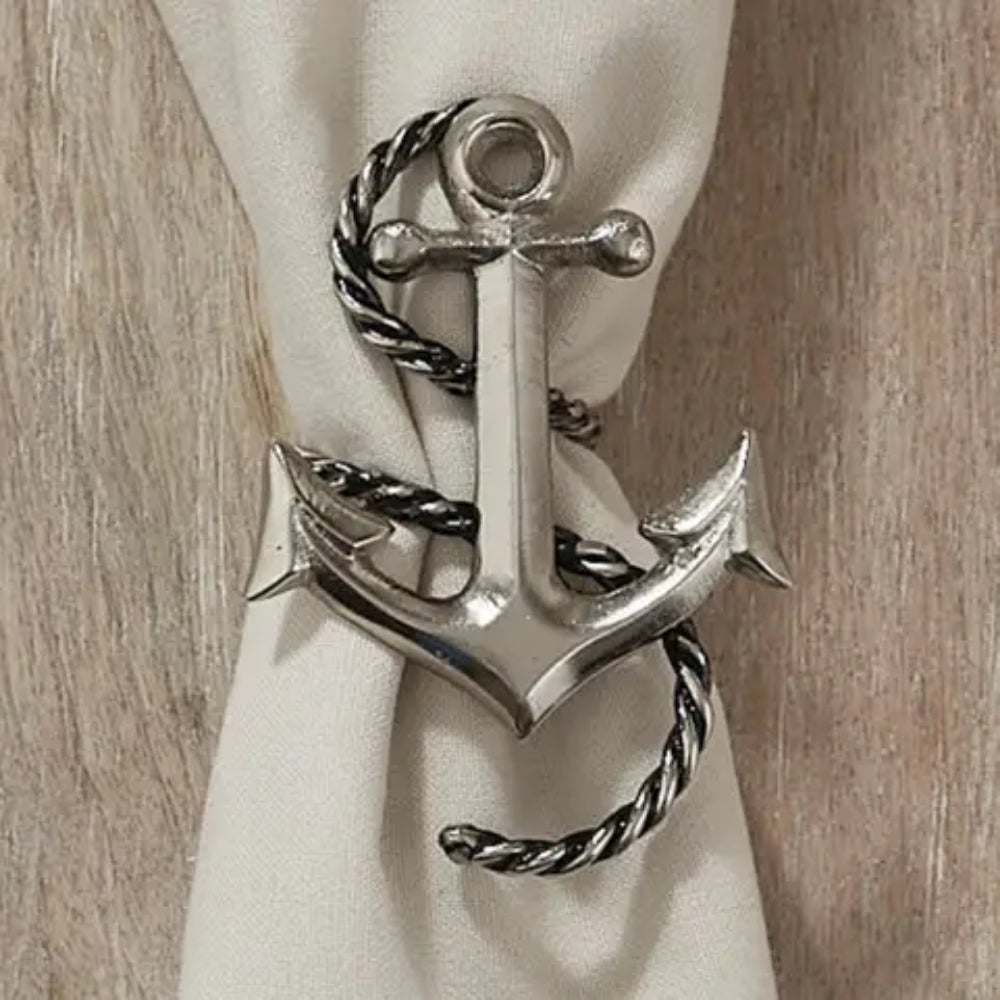 Anchor & Rope Napkin Ring around beige napkin on wooden surface.