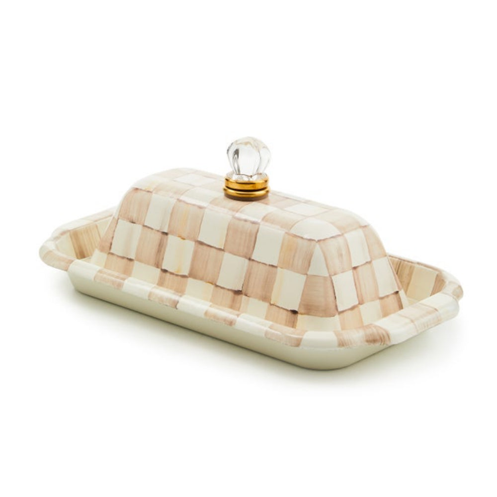 Butter dish with checkered pattern and glass lid on a white background