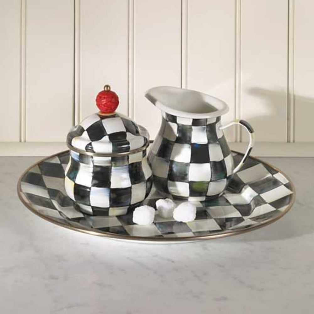 Black and white checkered teapot, sugar bowl, and creamer set on a matching platter.
