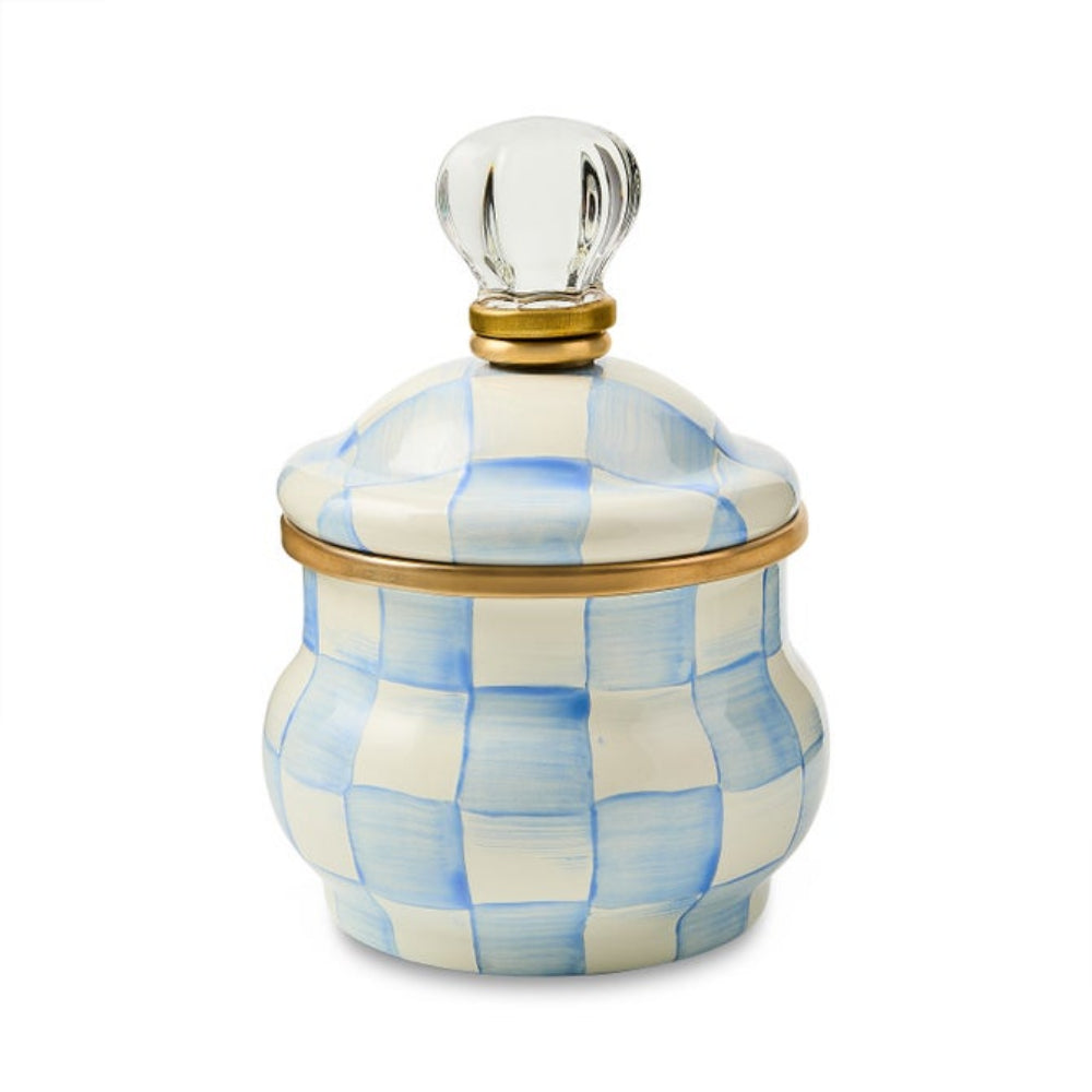 A decorative ceramic lidded container with a blue and white checkered pattern, a gold metal rim, and a clear glass knob on a white background.