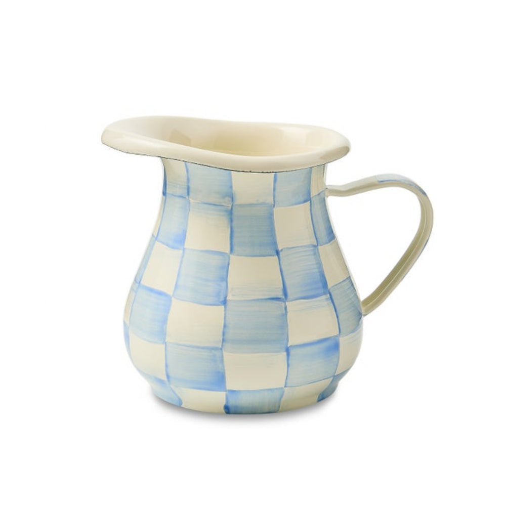 A ceramic creamer with a light blue and cream checkered pattern, featuring a wide rim, a curved handle, and a cream-colored interior, shown on a plain white background.