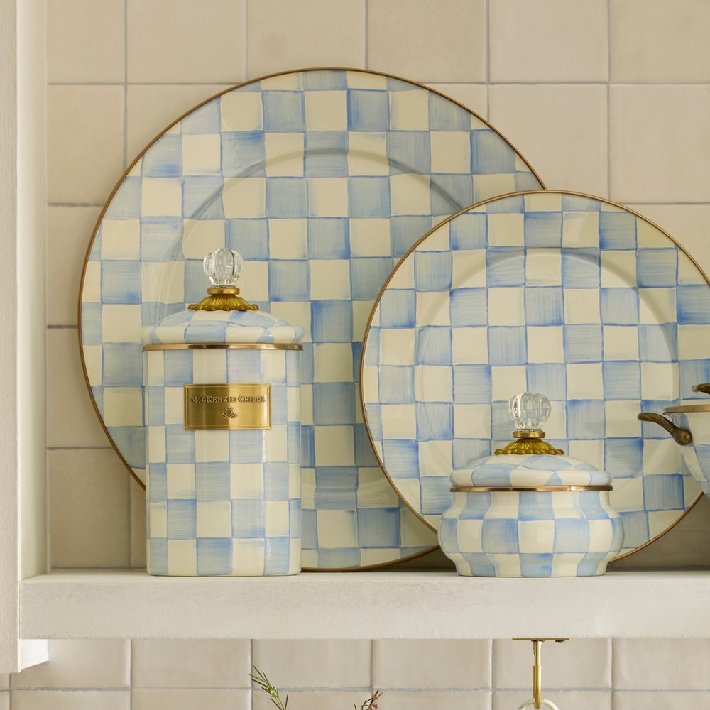 Decorative checkered plates with gold accents on a tiled wall.