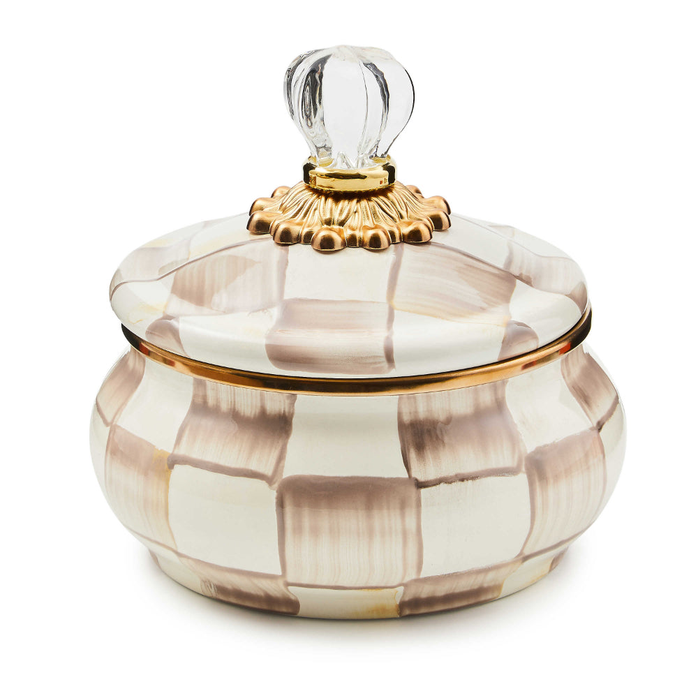 Decorative glass container with a checkered pattern and gold accents on a white background