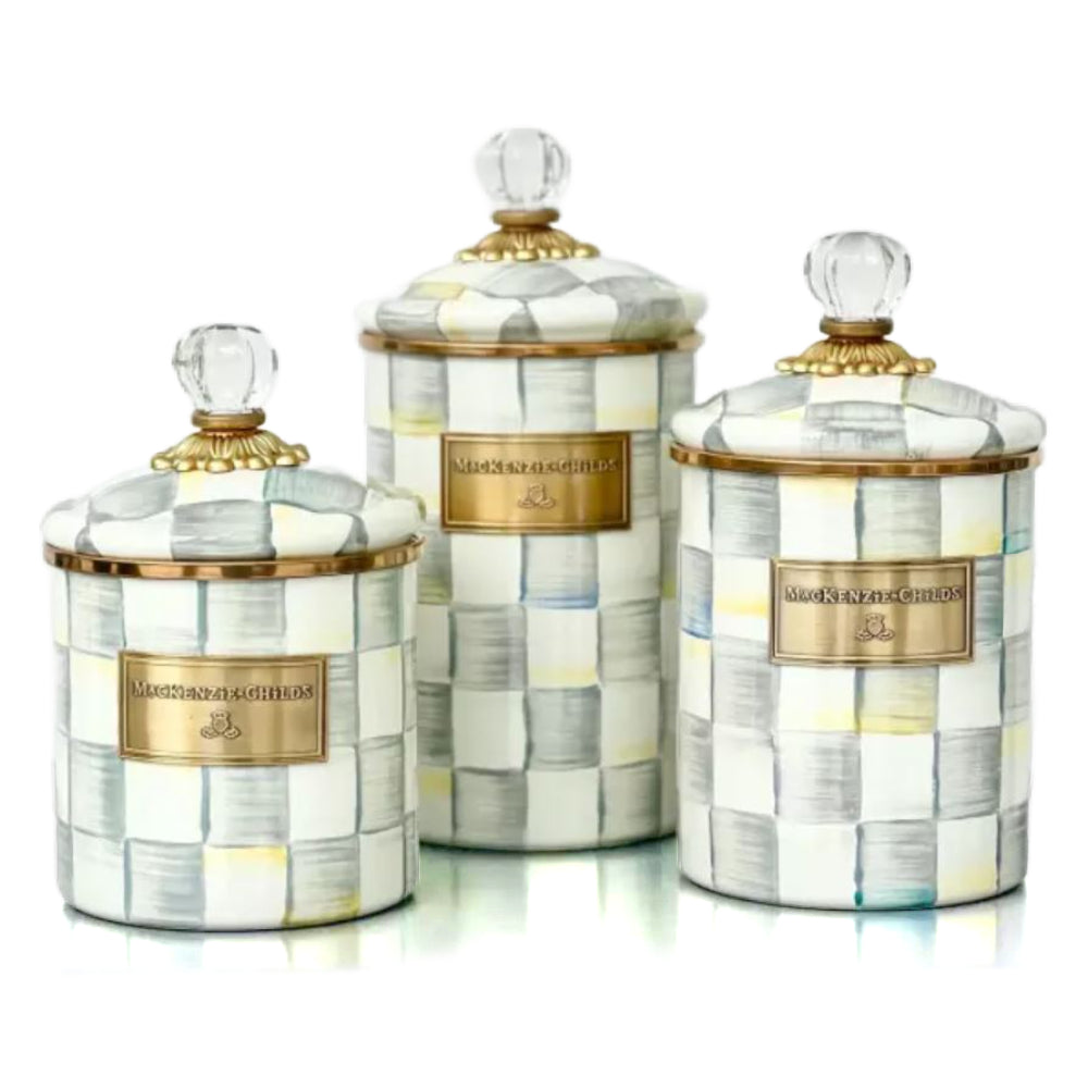 There differant sized Sterling Check canisters with checkered pattern and gold accents on a white background