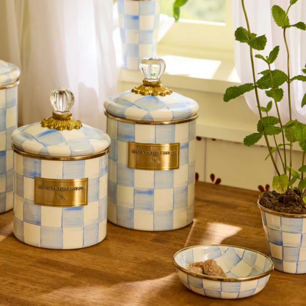 Decorative Sky Check canisters with checkered pattern and gold accents on a wooden surface. Surrounded by other Sky Check decor items. 