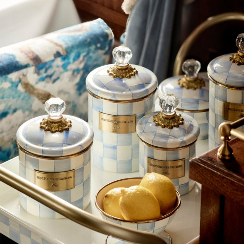 Decorative Sky Check canisters with checkered pattern and gold accents on a table.