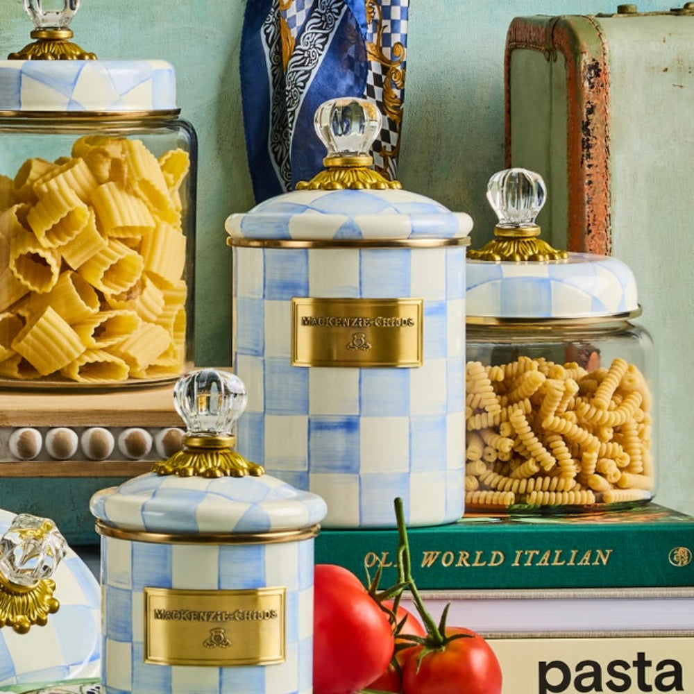 Decorative jars with pasta and tomatoes on a green surface with Sky Check Canisters on kitchen display. 