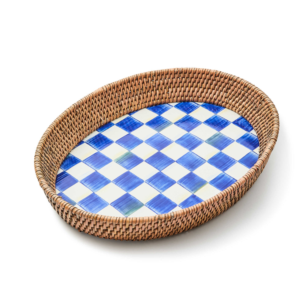 Large oval serving tray with a hand-painted blue and white checkered pattern on the base and a woven rattan rim.