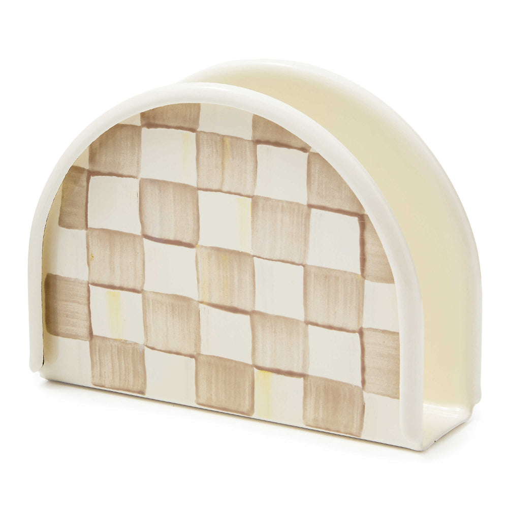 A beige and brown Mackenzie-Childs Mocha Check Napkin Holder made of enameled steel with a hand-painted, coffee-colored check pattern.