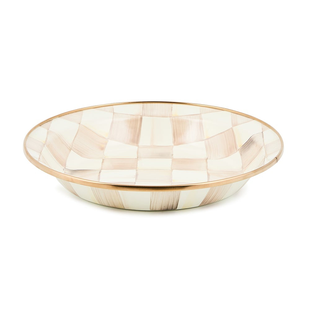 A shallow round bowl with a checkerboard pattern in cream, beige, and light brown, accented by a thin gold rim, shown on a plain white background.