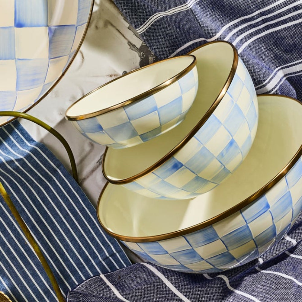 Set of ceramic sky check bowls with blue and white checkered pattern on a striped fabric background