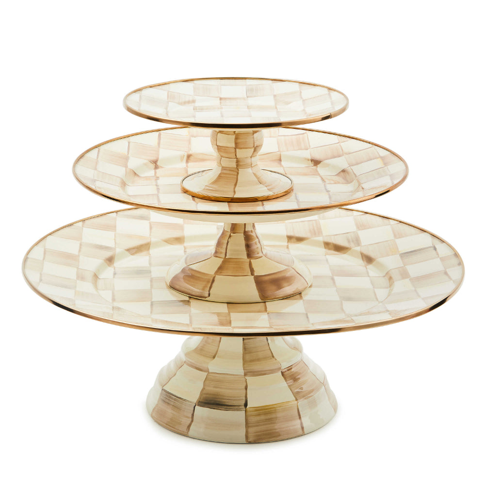 Multiple sized stacked decorative cake stand with a mocha check pattern on a white background.