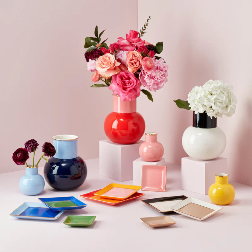 Kate Spade Make It Pop Cool Blue 3-Piece Tray Set with other tray sets and decor with vases with flowers on a pink backround. 