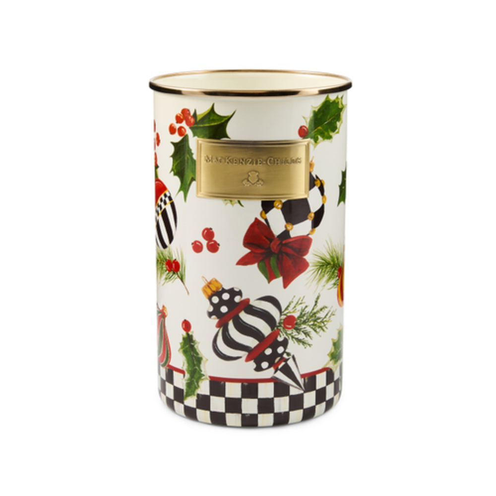 A cylindrical white Christmas-themed tin canister with a gold rim, decorated with a black and white striped zebra, red berries, green holly leaves, and a black-and-white checkered bottom border.