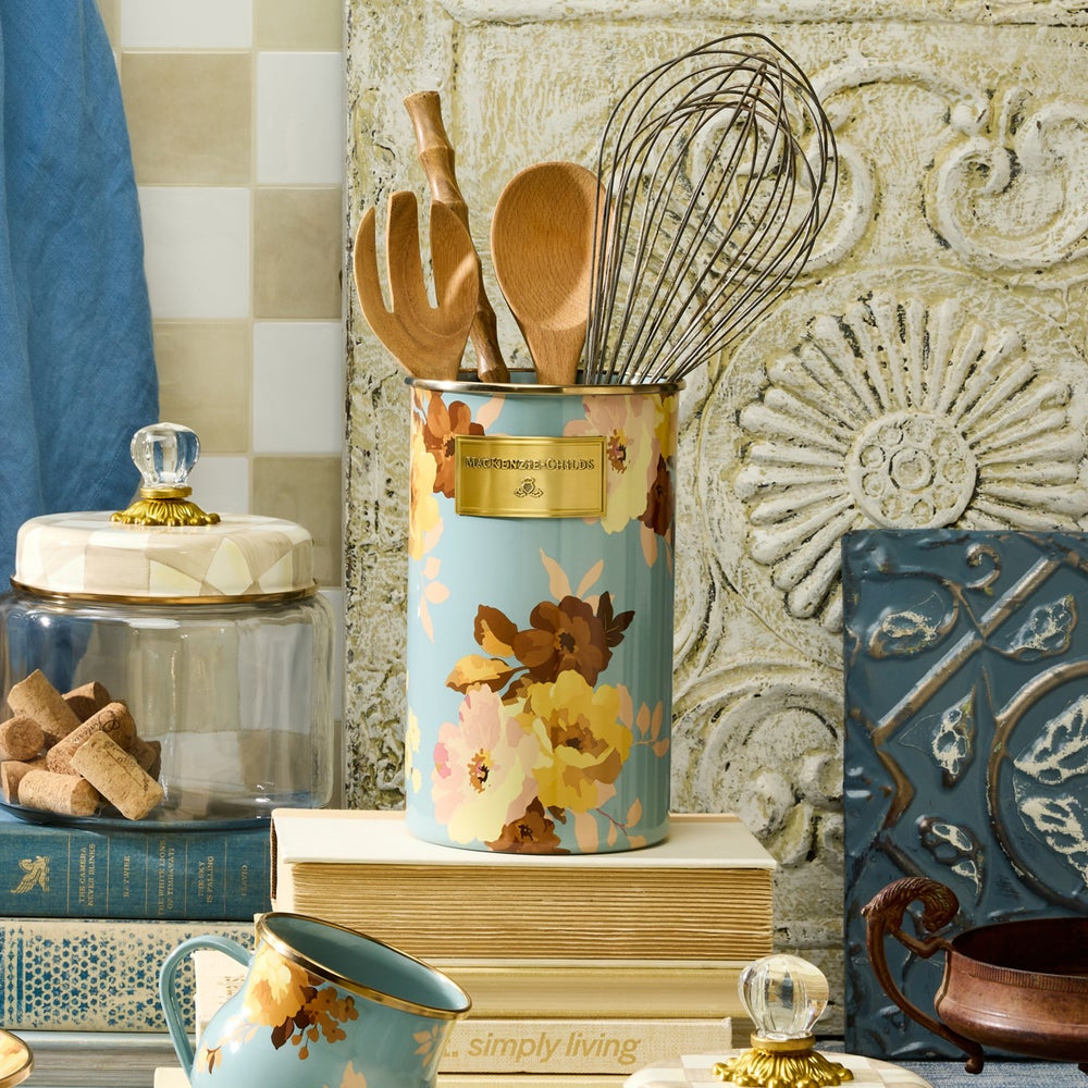 Decorative kitchen canister with floral design on a kitchen counter.