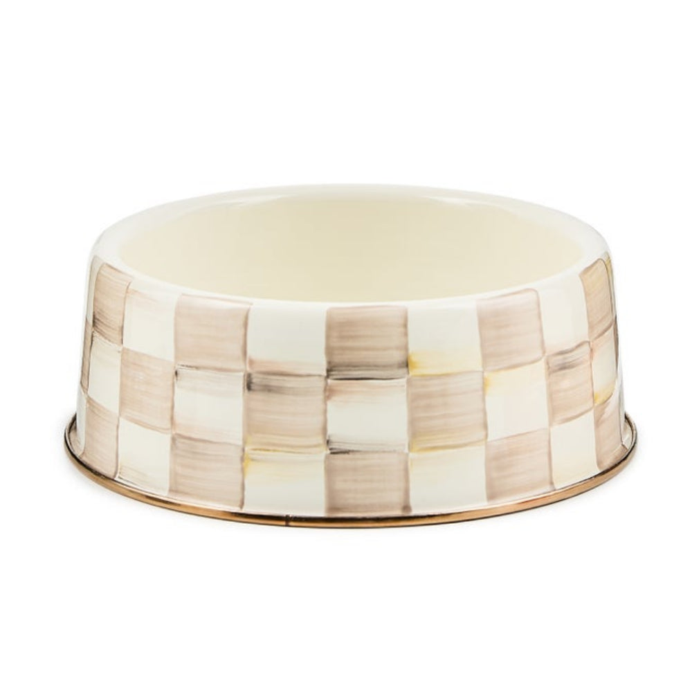 A ceramic pet bowl featuring a checkered pattern in cream, beige, and light brown, with a polished gold-toned metal rim, shown on a plain white background.