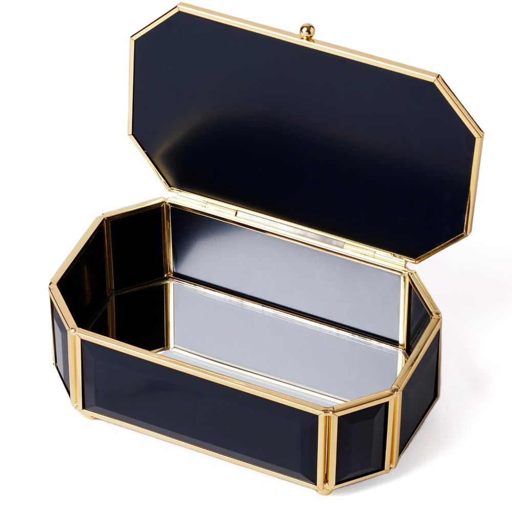 Opened black and gold hexagonal jewelry box on a white background.