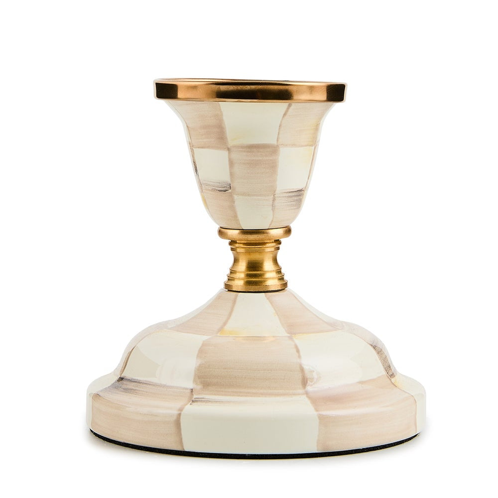 Decorative candle holder with gold accents on a white background