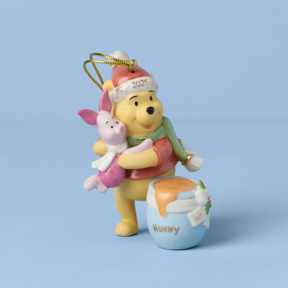 Decorative ornament featuring Winnie the Pooh and Piglet with a honey pot on a light blue background