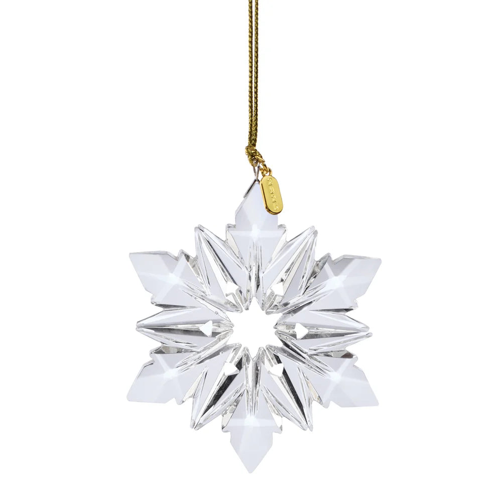 Crystal snowflake ornament with gold tassel on a white background