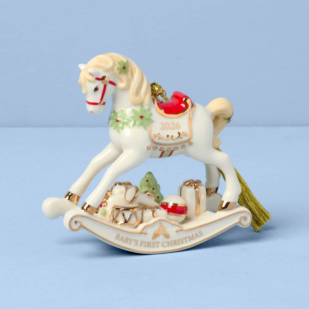 Decorative rocking horse ornament with 'Baby's First Christmas' and '2026' text on a light blue background 