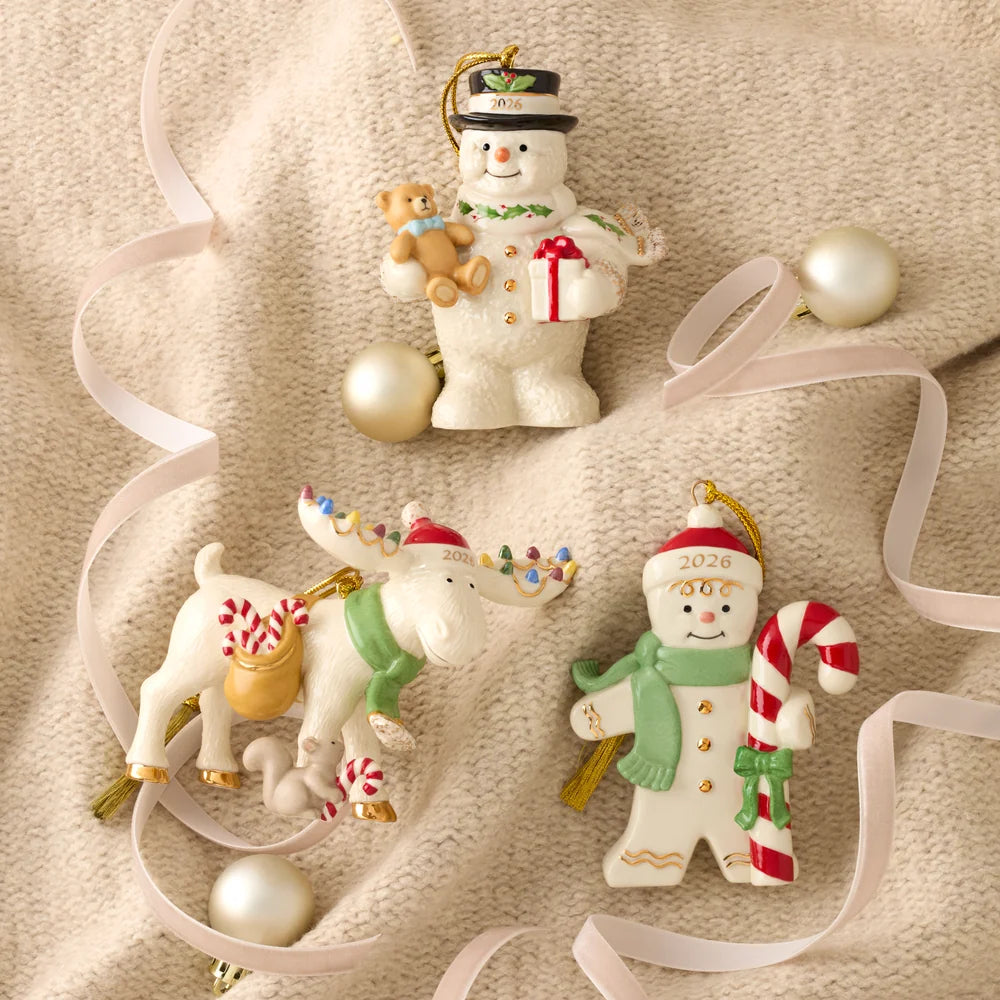 Three Christmas ornaments shaped like a snowman, reindeer, and a person with a candy cane on a beige background.